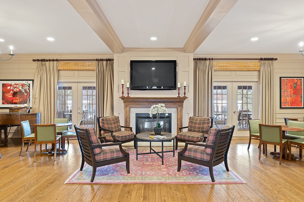 a living room with a fireplace and a table and chairs at Indian Creek Apartments*, Cincinnati, OH