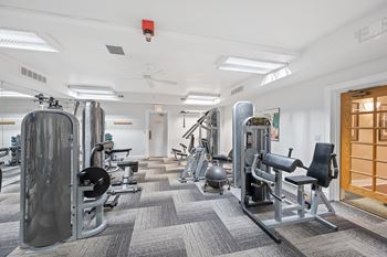 a row of fitness equipment in a room with yoga machines at Indian Creek Apartments*, Cincinnati, OH