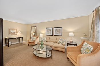 a living room with couches and chairs and a table at Indian Creek Apartments*, Cincinnati, Ohio