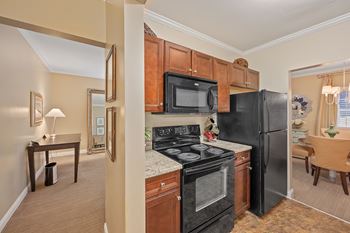 a kitchen with black appliances and a black refrigerator at Indian Creek Apartments*, Cincinnati, OH