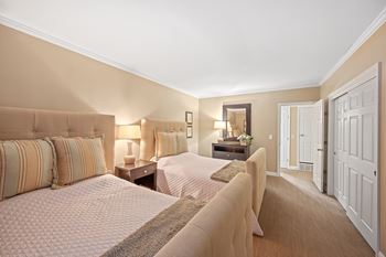 a bedroom with two beds and a door to a bathroom at Indian Creek Apartments*, Ohio, 45236