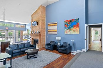 Living room with blue walls and a brick fireplace at Indian Lookout, Ohio