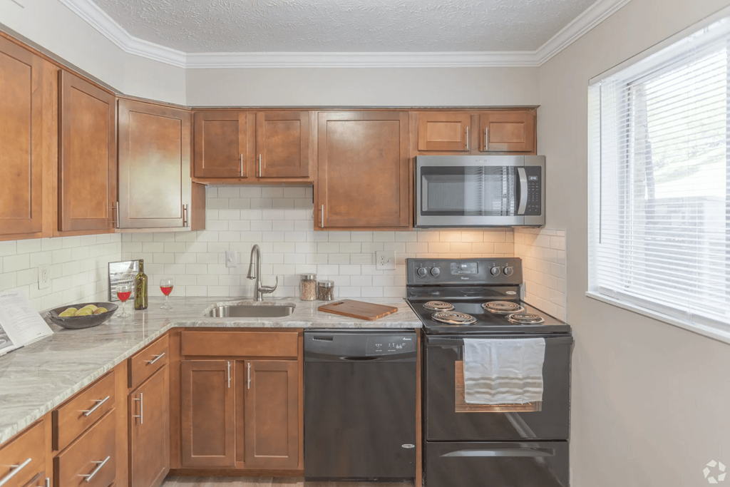 Kitchen with brown wooden cabinetry at Trails at Mariemont, Ohio