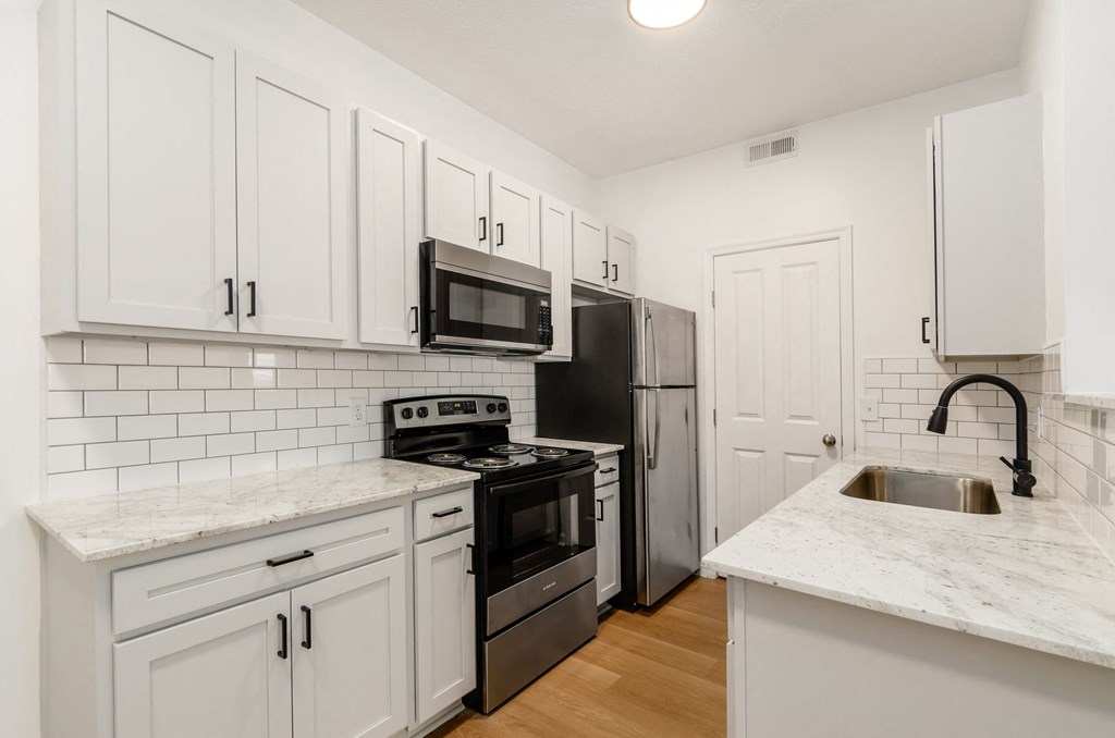 a kitchen with white cabinets and stainless steel appliances at Prescott Place, Columbus, OH