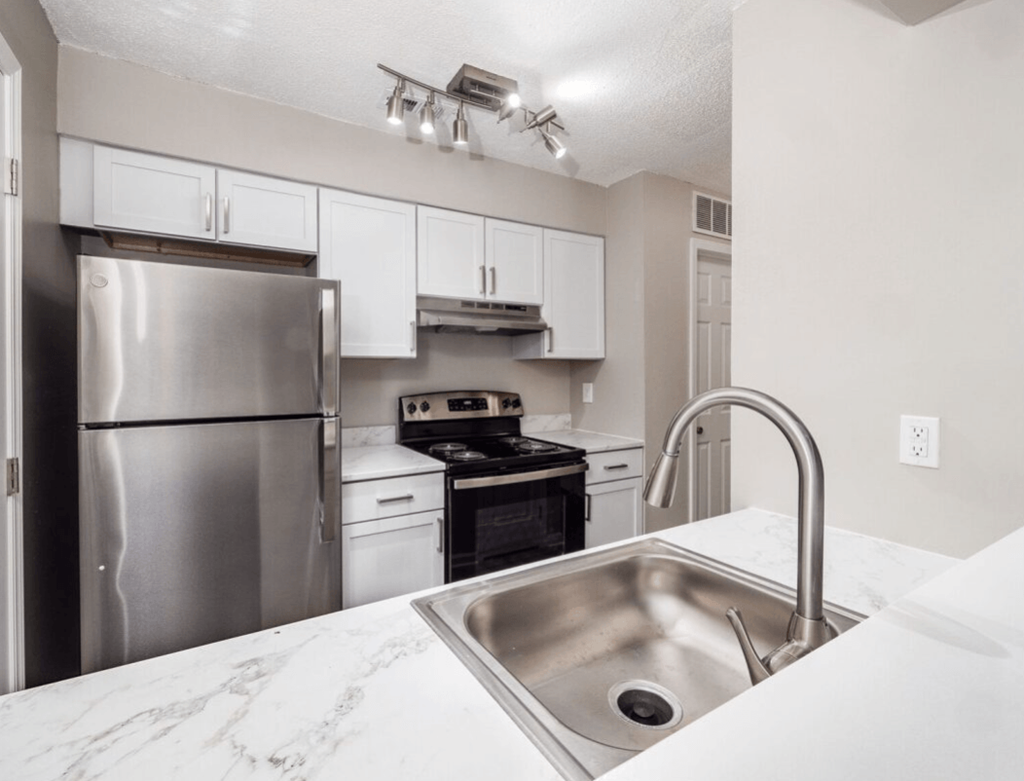 a kitchen with stainless steel appliances and a sink at The Berryessa Apartments, Ohio