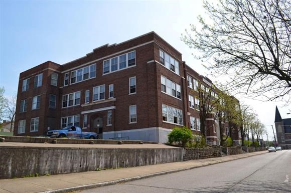 a red brick building on the side of a street