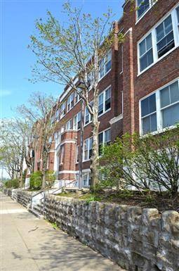 a brick building with a sidewalk in front of it