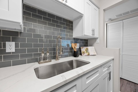 A kitchen with a sink and a counter.
