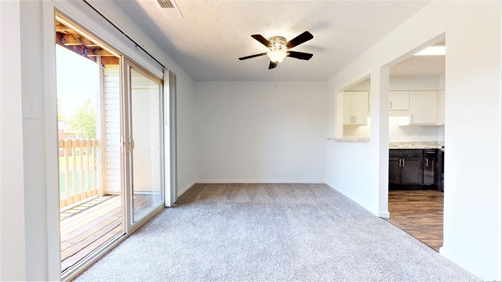 a living room with a ceiling fan and a glass door to a kitchen at Lawrence Landing, Indiana, 46226