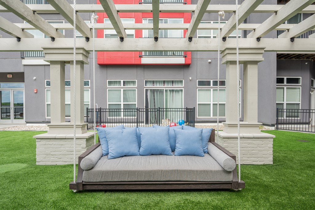 a couch on a lawn in front of a building