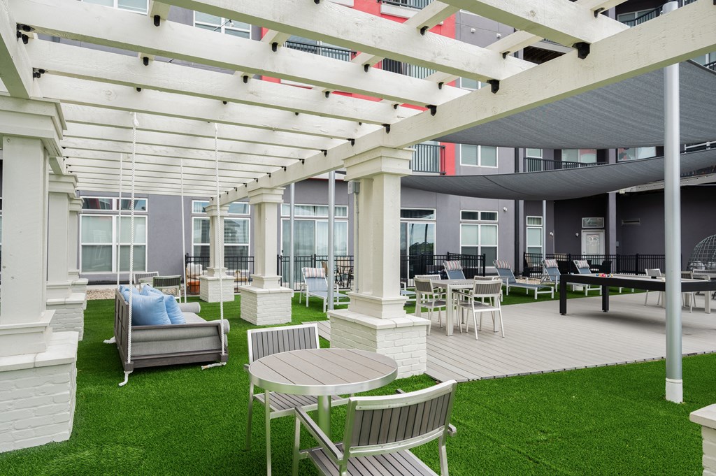 a patio with chairs and tables and a