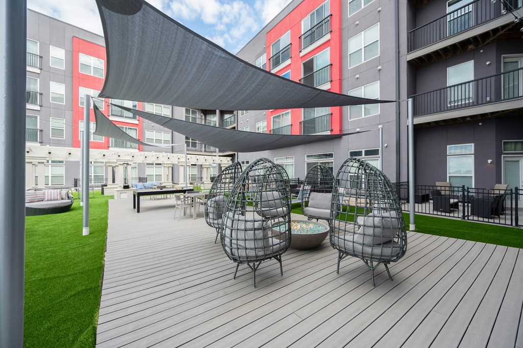 a large patio with chairs and tables and a canopy