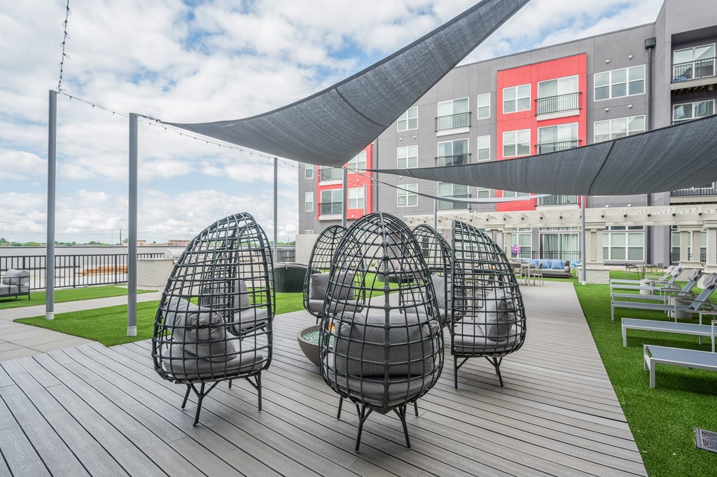 a group of chairs sitting on top of a wooden deck