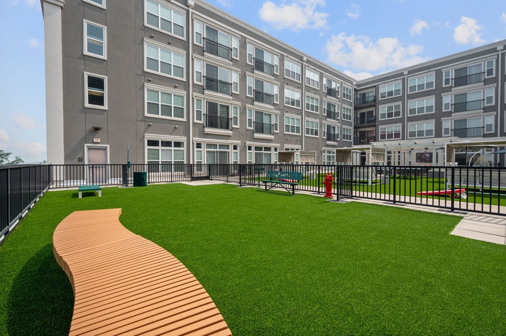a large green lawn in front of an apartment building