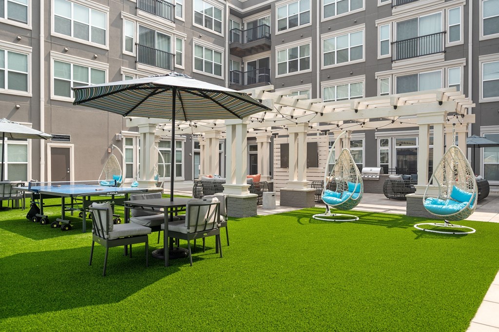 a courtyard with tables and chairs and umbrellas