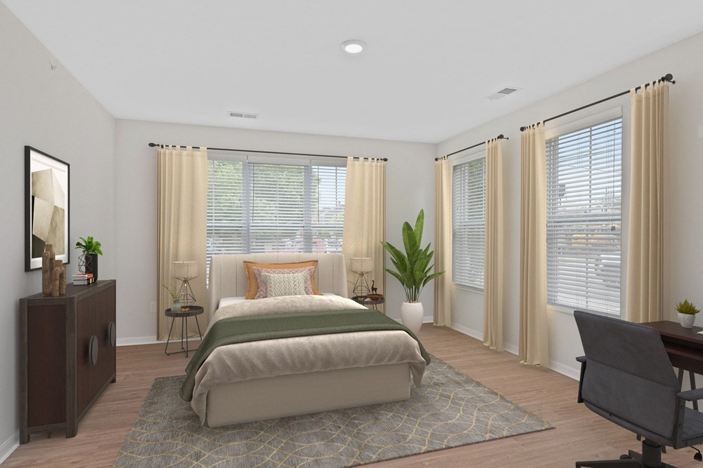 a bedroom with a bed and a desk and windows at Monmouth Row Apartments, Kentucky