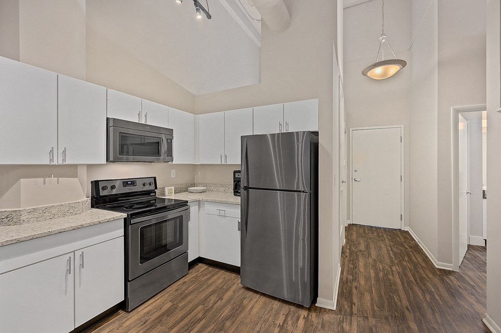 a kitchen with black appliances and white cabinets