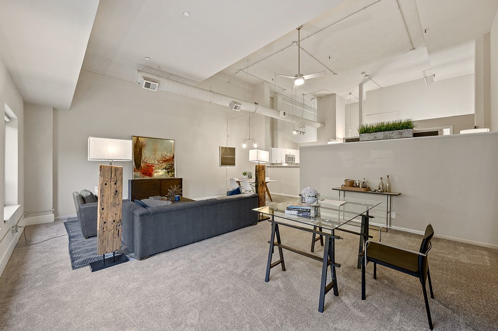 a living room with a glass table and a couch