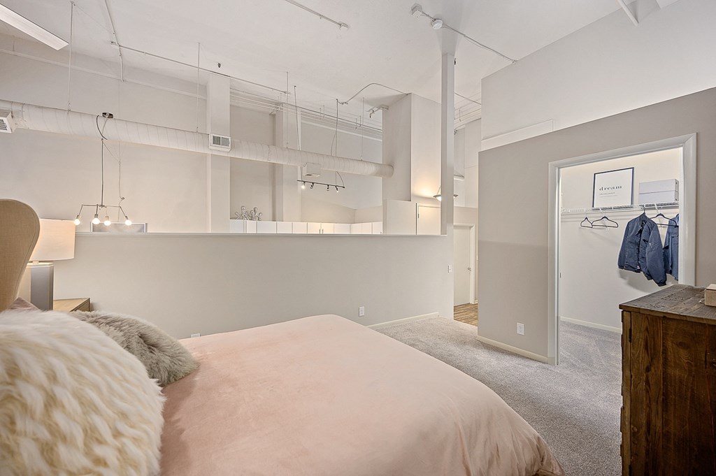 a bedroom with a bed and a closet and a mirror