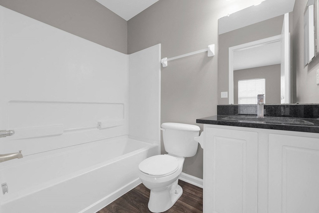 a white bathroom with a toilet and a bath tub at Traditions at Slate Ridge, Ohio, 43068