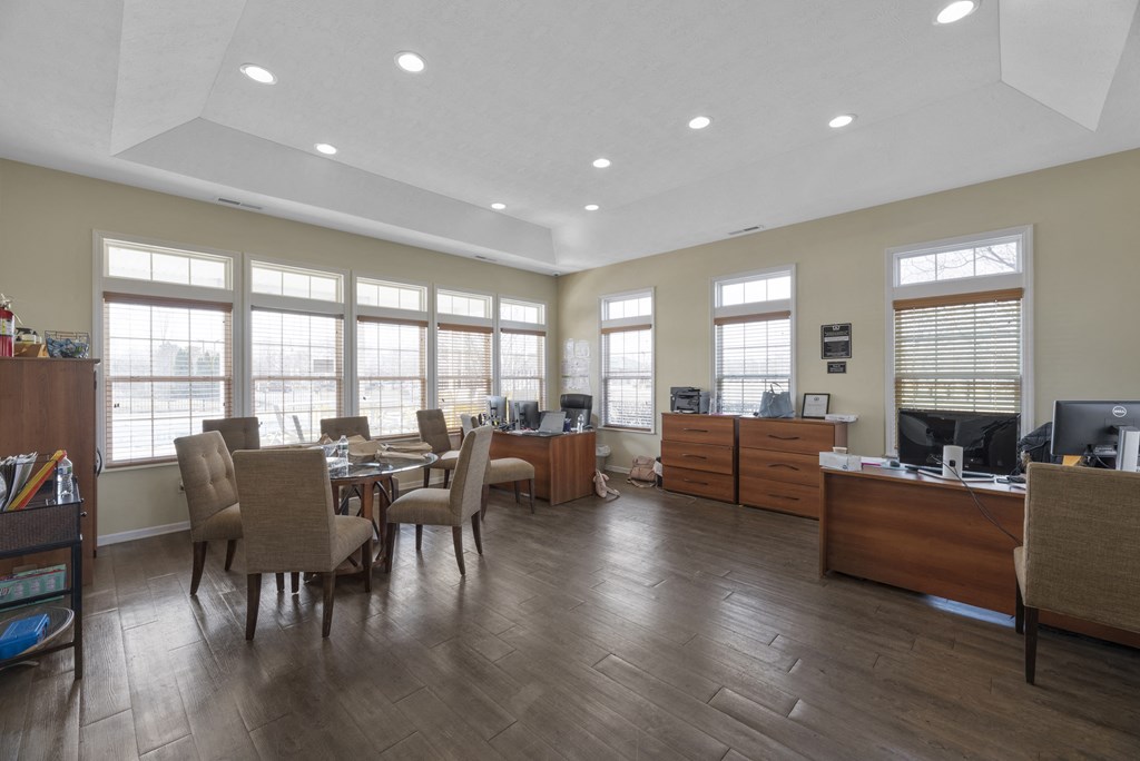 a dining room with a table and chairs and a living room with windows at Traditions at Slate Ridge, Reynoldsburg, OH 43068