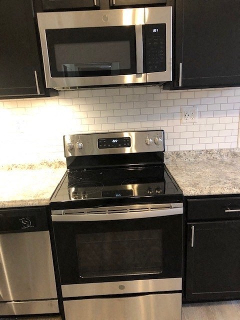 a kitchen with a stove and a microwave