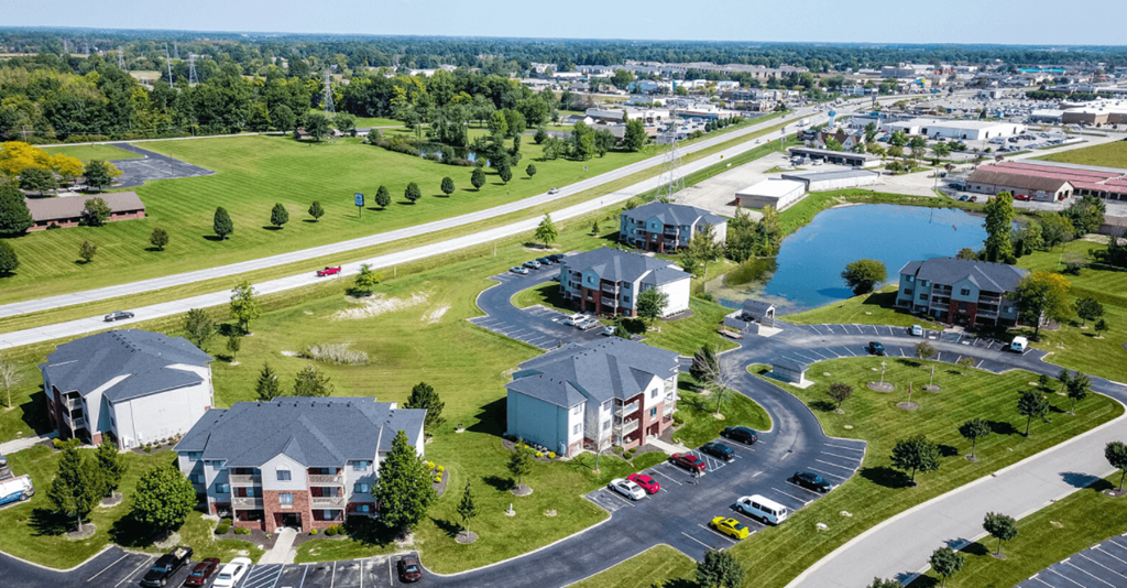 an aerial view of a neighborhood with houses and a parking lot