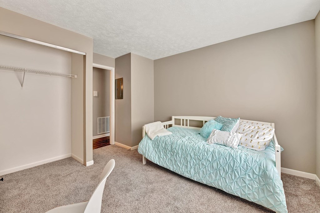 a bedroom with a bed and a closet