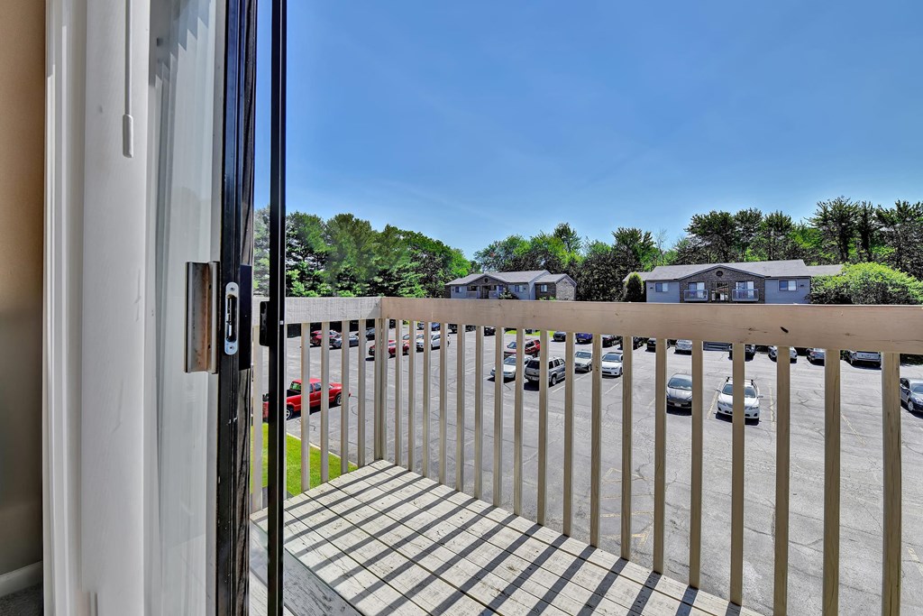 a balcony with a view of a parking lot