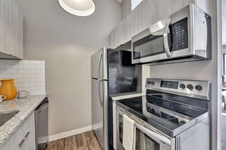 a kitchen with stainless steel appliances and a microwave
