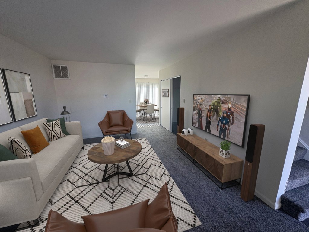 A living room with a couch, chairs, and a coffee table.