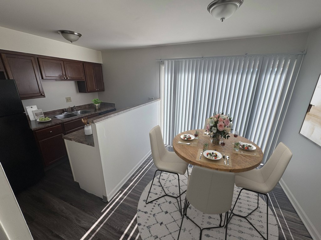 A kitchen with a dining table set for four.