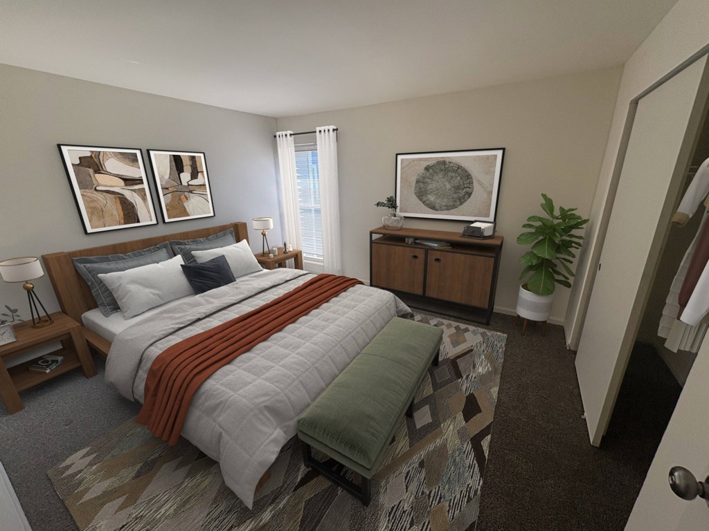 A bedroom with a bed, nightstand, and a plant.