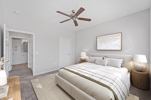 A bedroom with a large bed and a ceiling fan. at Monmouth Row Apartments, Newport, KY