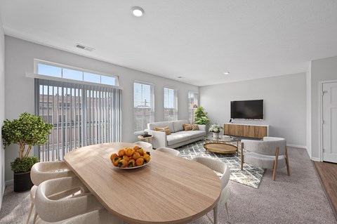 A modern living room with a wooden table and white chairs. at Monmouth Row Apartments, Newport, 41071