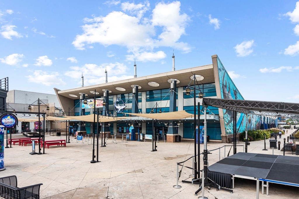 a large building with tables and umbrellas in front of it at Monmouth Row Apartments, Newport, KY