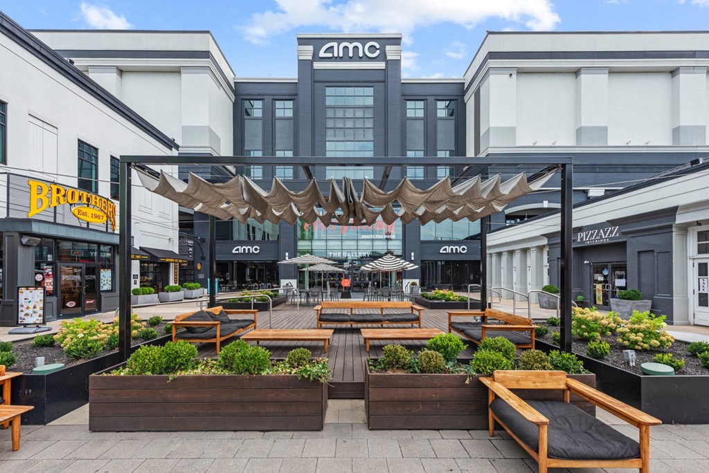 a courtyard with benches and tables in front of a building at Monmouth Row Apartments, Newport, 41071