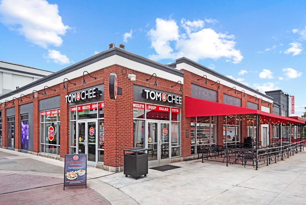a brick restaurant with a red awning at Monmouth Row Apartments, Newport, Kentucky
