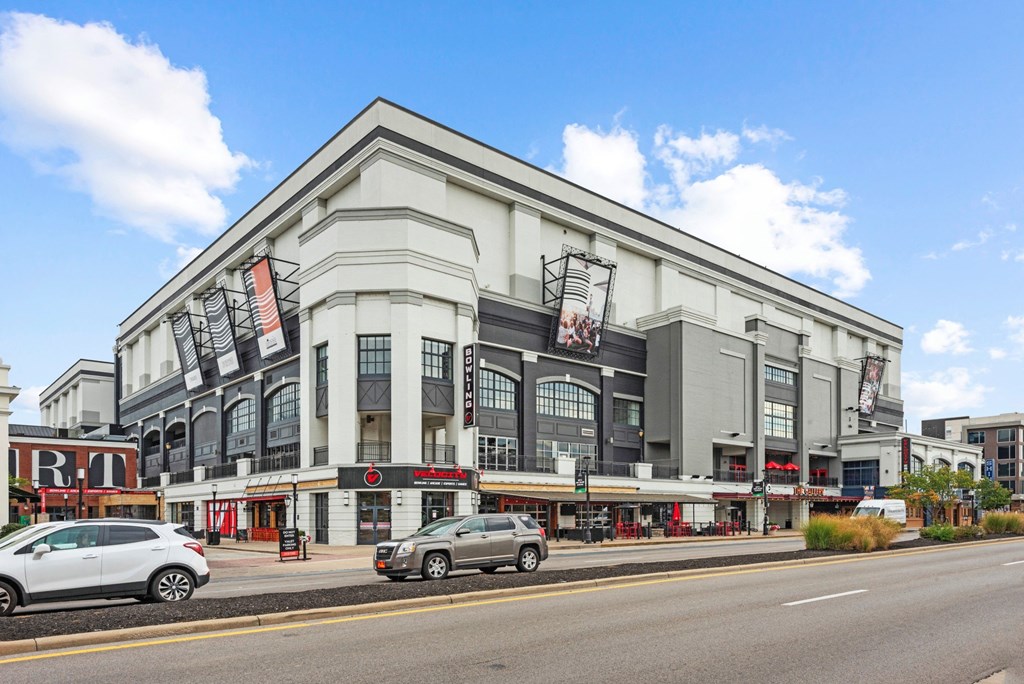a large building with cars parked outside of it on a city street at Monmouth Row Apartments, Newport, 41071