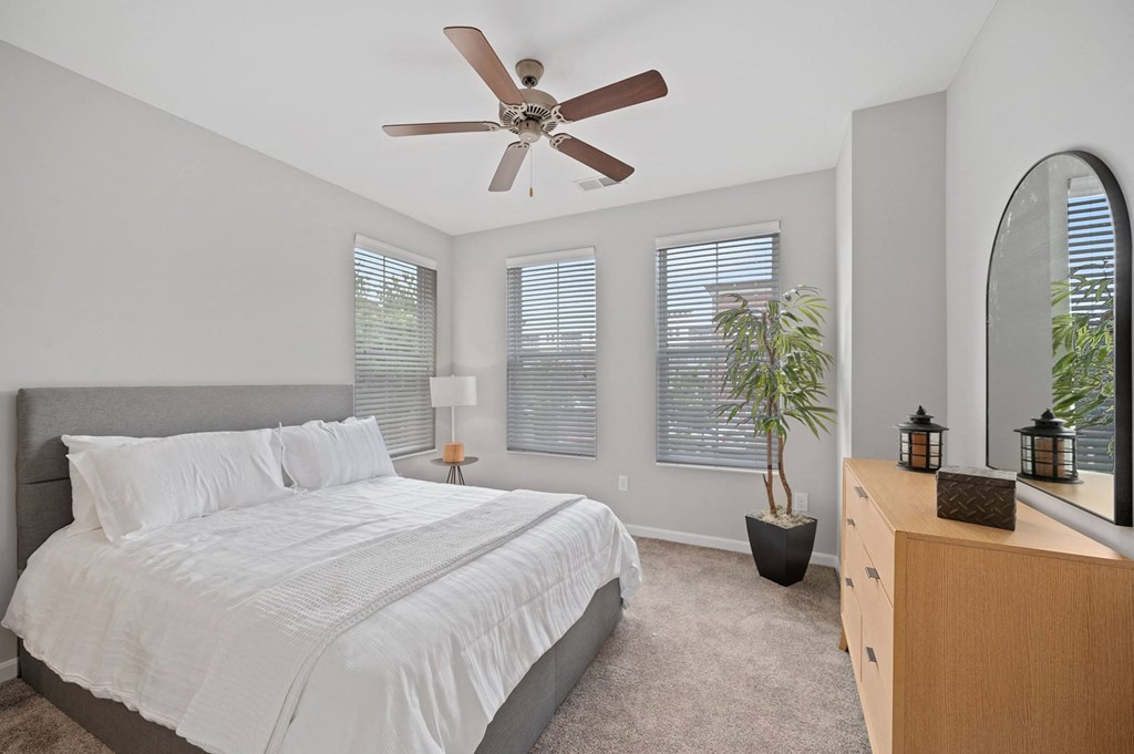 a bedroom with a large bed and a ceiling fan at Monmouth Row Apartments, Newport, KY