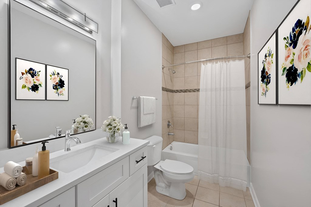a bathroom with a sink toilet and a shower at Monmouth Row Apartments, Newport, KY