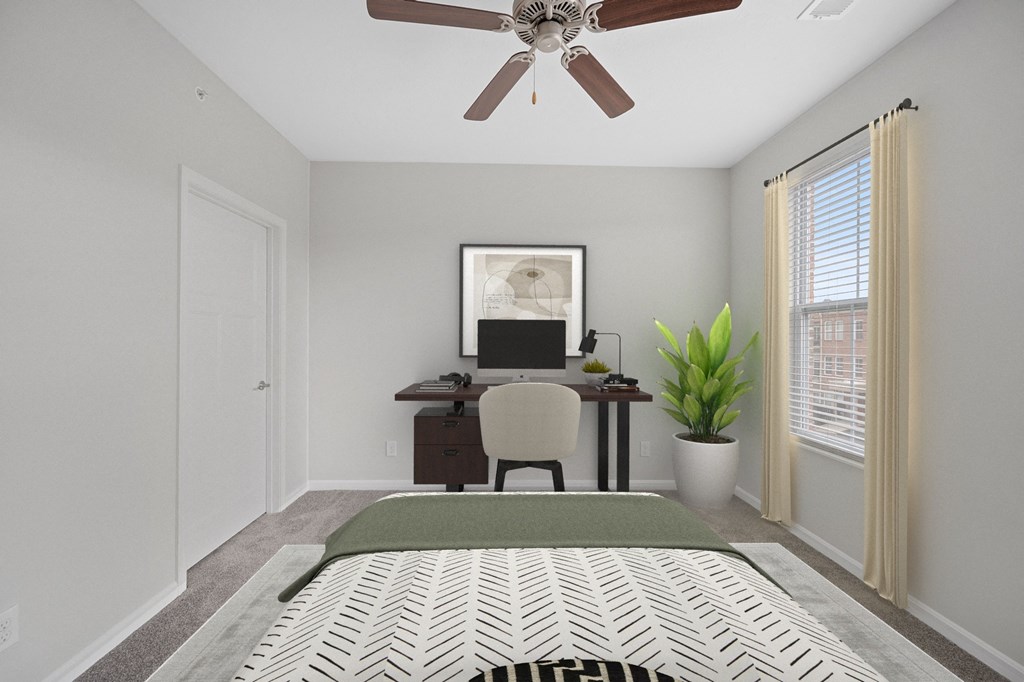 a bedroom with a large bed and a desk with a computer at Monmouth Row Apartments, Newport, KY