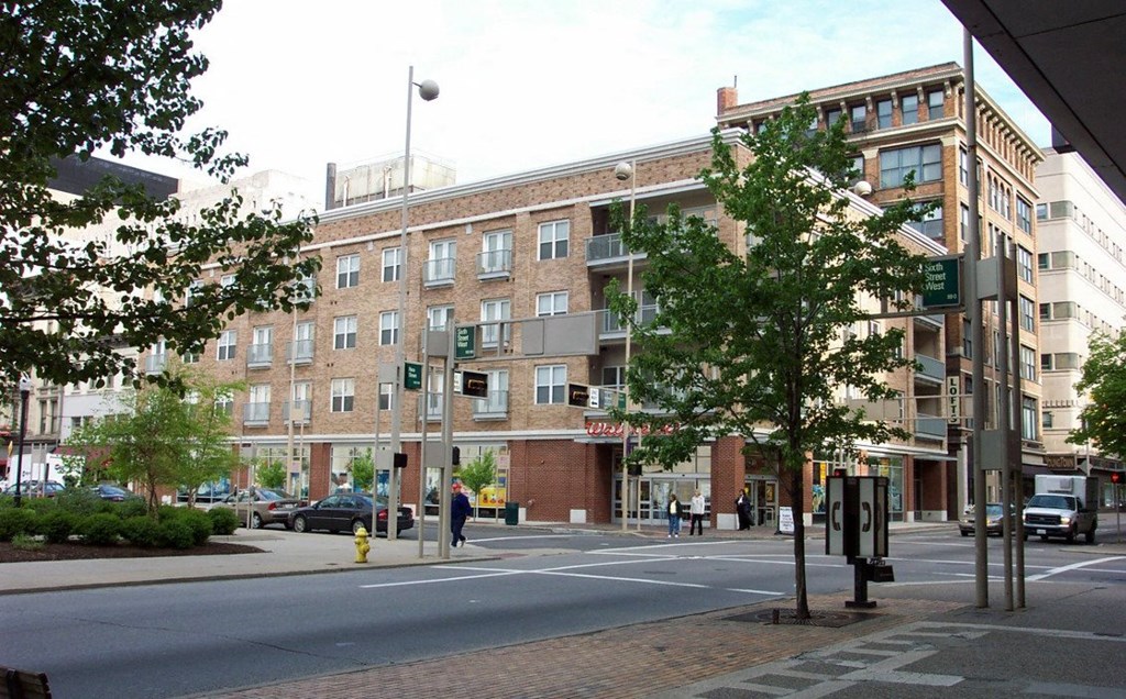 a large brick building on the corner of a city street