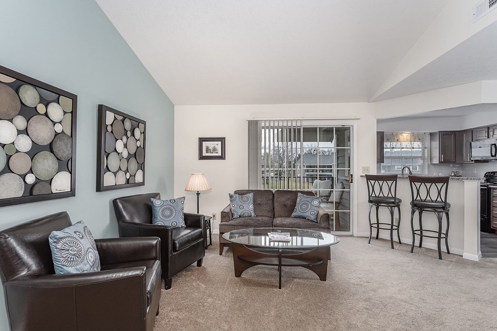 Living room decor with wall frames and antiques at Normandy Club, Centerville