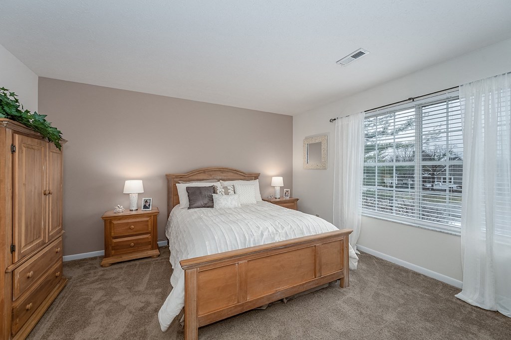 Bedroom with cozy bed and window view at Normandy Club, Ohio, 45459