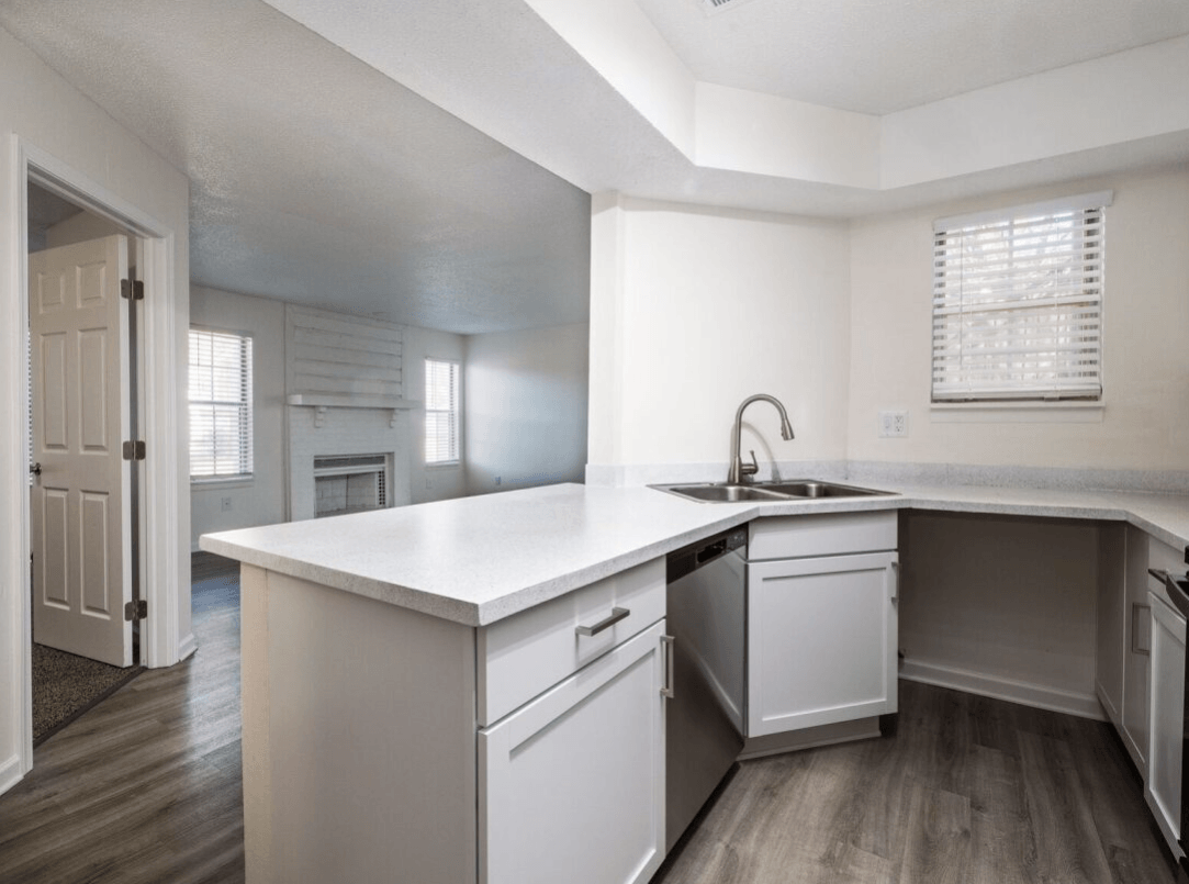 the kitchen of a new home with white cabinets and a white counter top