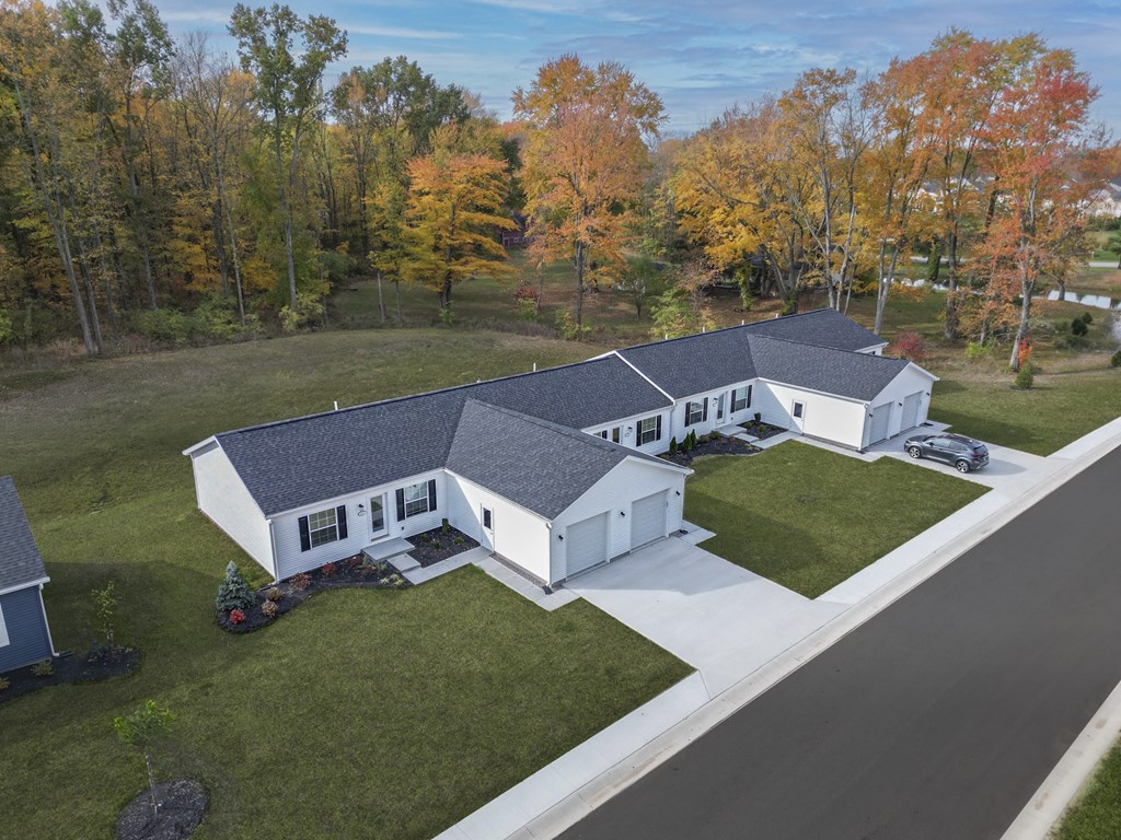 a birds eye view of a white house with a gray roof