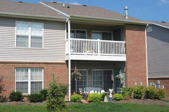 A house with a white porch and a grey roof.