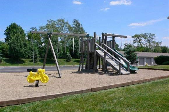 a playground with a swing set and a slide