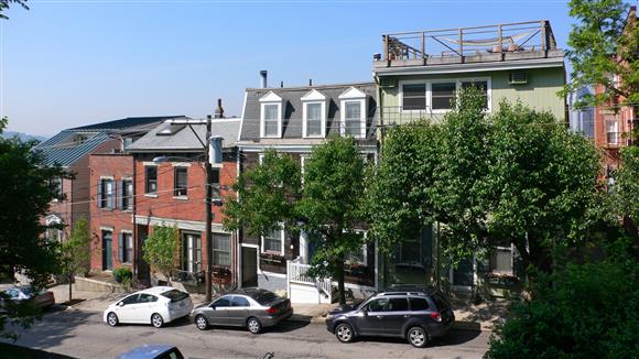 a street with cars parked in front of houses